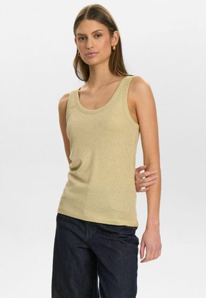 Light beige ribbed tank top with wide scoop neckline, fitted shape, soft texture, paired with dark denim jeans.