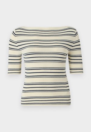 Maglia di colore bianco sporco con righe orizzontali nere, maniche lunghe al gomito e ampio scollo a barca.