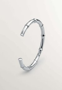 Pulsera de plata en forma de bambú con diseño segmentado, textura suave, cuenta con extremos redondeados y secciones de bambú de diferentes longitudes.