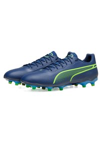 Scarpe da calcio blu navy con superficie texture, accenti verdi e design aerodinamico. Include lacci e tacchetti multicolori.
