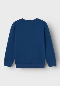 Sudadera azul marino vista desde la parte de atrás, con cuello redondo, puños acanalados y una textura simple y suave. Sin logotipos ni patrones visibles.