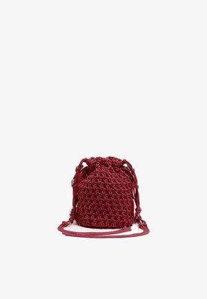 Borsa intrecciata rossa con chiusura a coulisse e tracolla regolabile. Presenta una superficie tessurizzata e una forma rotonda, accentuata da hardware resistente.