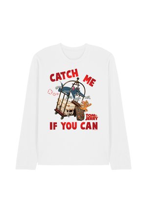 Tom chasing Jerry on a luggage cart with suitcases, text "Catch me if you can" and Tom & Jerry logo on white long-sleeve shirt.