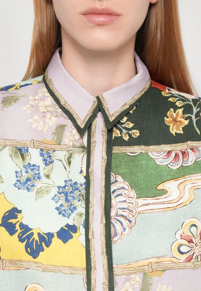 Floral patterned shirt featuring multicolored sections, lightweight fabric, a collared design, and contrasting bamboo-style trim.