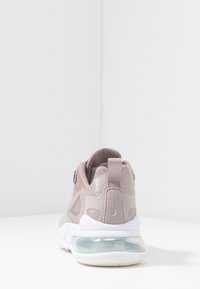 Nike air sneaker featuring a light pink suede upper, mesh panels, a padded collar, and a translucent air cushioning unit in the sole.
