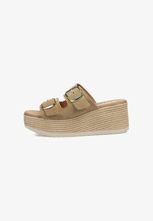 Sandalias de plataforma beige con dos tiras abrochadas y una suela trenzada. El diseño presenta un aspecto casual y elegante, adecuado para el clima cálido.