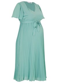 Zavinovací těhotenské šaty v světle mátové barvě, s véčkovým výstřihem, krátkými rukávy, zavázaným pasem a splývavou sukní. Měkká textilie.