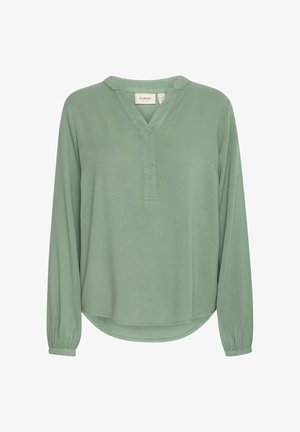 Hellgrüne Bluse mit langen Ärmeln und strukturiertem Finish, V-Ausschnitt und elastischen Ärmelbündchen. Abgerundeter Saum mit dezentem Stickdetail.