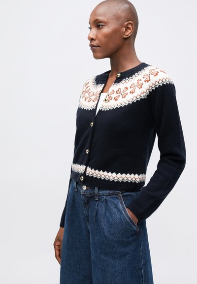Cárdigan de punto en azul marino con diseño fair isle en crema y óxido, que presenta un cuello redondo, cierre de botones y puños acanalados.