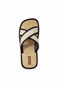 Tan and black flip-flop sandal with a woven bamboo footbed, featuring cream canvas straps in an X-cross pattern and a branded patch.