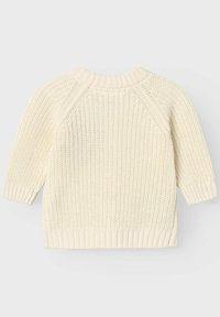 Kremno bele pletene pulover s teksturiranim vzorcem, raglan rokavi in rebrastimi manšeti ter robom. Mehak, lahek material.