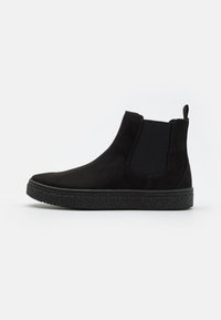 Black suede Chelsea boots with elastic side panels and a textured black rubber sole. Features a pull tab for easy wear.