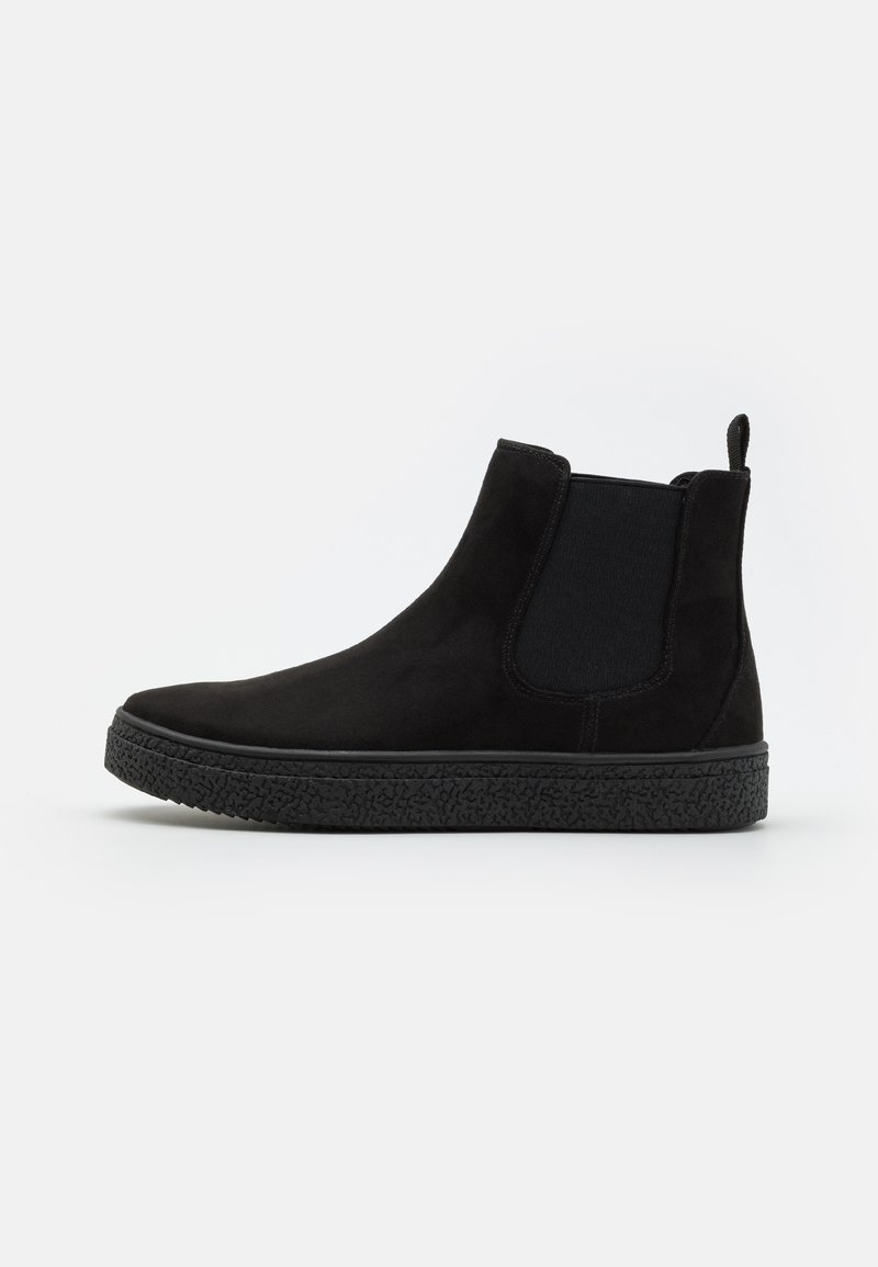 Black suede Chelsea boots with elastic side panels and a textured black rubber sole. Features a pull tab for easy wear.