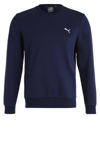 Námořnická modrá mikina vyrobená z měkké tkaniny, s kulatým výstřihem, dlouhými rukávy a bílým logem Puma na hrudi. Hladká textura.