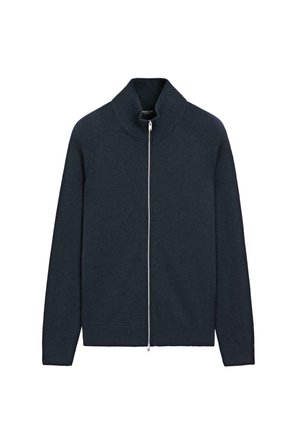 Donkerblauwe sweater met ritssluiting, hoge kraag, geribbelde mouwen en schouders, gladde lichaamstextuur en zilveren ritssluitingdetail.