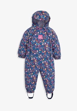 Tamsiai mėlynas vandeniui atsparus kombinezonas su spalvingu gėlių raštu, elastingais rankogaliais ir reguliuojama kapišonu. Yra priekinis užtrauktukas ir pėdų diržai tvirtam pritaikymui.