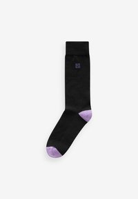 Black sock with a purple heel and toe. Features a subtle logo in purple near the top. Made from a smooth, stretchy fabric.