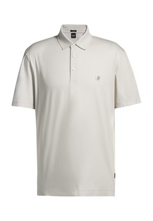 Light beige polo shirt made from smooth fabric, featuring a classic collar, three-button placket, and a small embroidered logo on the left chest.