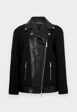 Mustükkile järjehoidev jope, millel on nahast esipaneel ja krae, tekstuuriga kootud riidest varrukad, lukuga taskud ja metallist aktsendid.