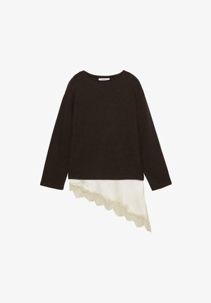 Czarna bluzka z długim rękawem, z asymetrycznym, białym jedwabnym dołem i koronkową lamówką wzdłuż dolnej prawej strony.