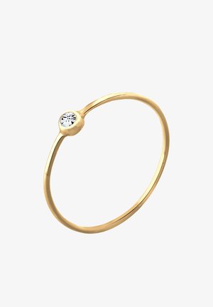 Inel de aur cu un știu subțire și un montaj rotund, având o singură piatră prețioasă clară în centru. Finisaj neted și lustruit.