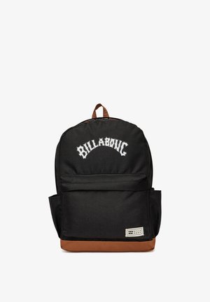 Black Billabong backpack with brown base, front zipper pocket, side pockets, top handle, and white logo text on front.