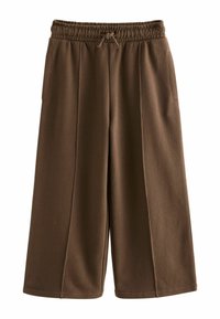 Brune, brede sweatpants lavet af blødt stof. Elastisk talje med justerbart snøre. Har to sidelommer og syddetaljer.