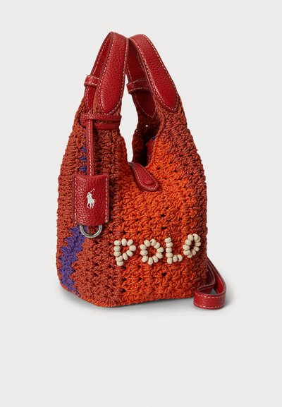 Πλεκτή πορτοκαλί και κόκκινη τσάντα χειρός από υλικό κροσέ, με καρφιτσωτό λογότυπο "POLO", λουρί και κόκκινα δερμάτινα στοιχεία. Μοναδική υφή και σχήμα.