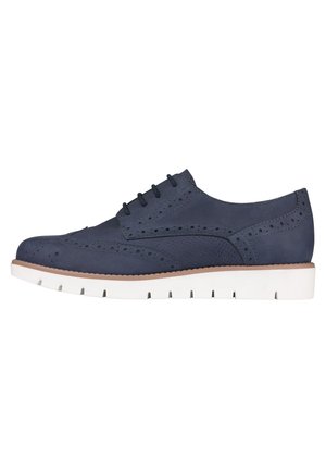 Granatowe skórzane buty typu brogue z perforowanymi detalami, czarne sznurowadła oraz biała gumowa podeszwa z rowkami zapewniającymi przyczepność.