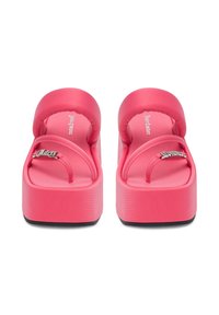 Bright pink platform sandals with thick padded ankle straps and metallic logo detail on toe straps, front view.