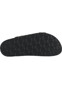 Schwarze Schuhsohle mit einer strukturierten Oberfläche, die geometrische Muster aufweist und für Halt und Langlebigkeit ausgelegt ist. Flache Form mit abgerundeten Kanten.