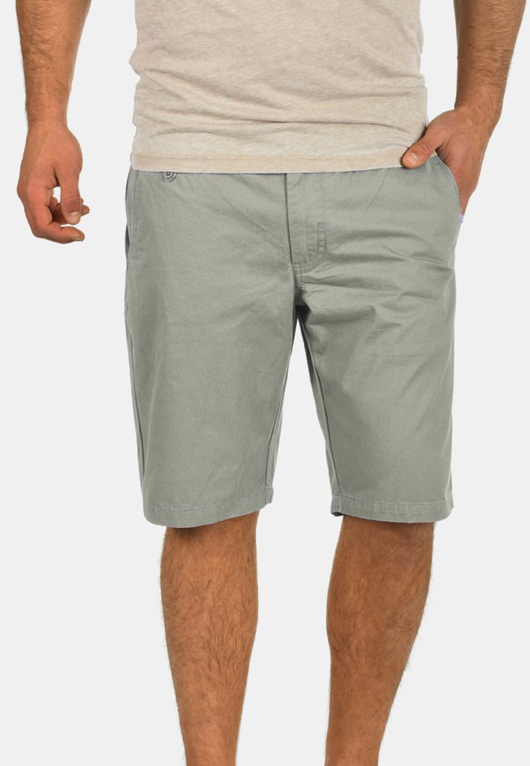 Light gray cotton shorts with a relaxed fit, featuring side pockets and a flat front. The fabric has a soft texture and a smooth finish.