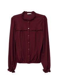 Burgunderfarbene Bluse mit langen Ärmeln, Rüschensaum und -bündchen, Knopfleiste und strukturiertem Stoff. Sie hat einen gerafften Saum und ein Rüschendetail vorne.
