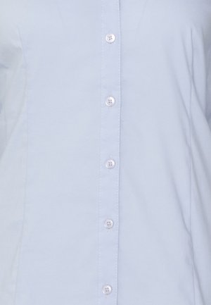 Light blue button-up shirt with five white buttons and visible stitching along the button line.
