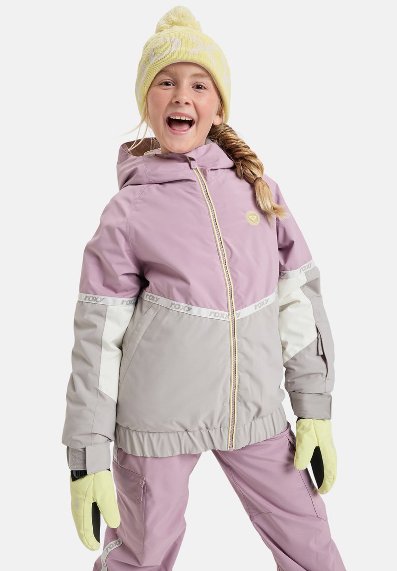 Purple and gray insulated jacket with a hood, featuring white accents, a yellow zipper, and a yellow pom-pom beanie. Gloves are yellow.