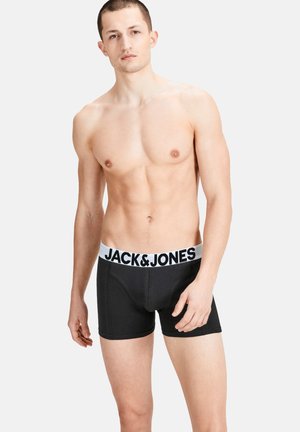 Black boxer shorts with a white elastic waistband featuring 'JACK & JONES' branding. Soft, stretchable fabric, fitted design.