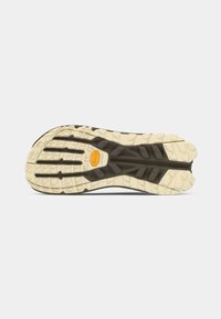 Black and cream rubber outsole with multidirectional lugs; features a textured design for traction; Vibram branding visible at the center.