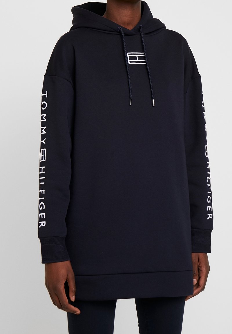 Merinavy hooded sweatshirt with front pocket, logo accents on the chest and sleeves, and ribbed cuffs at the sleeves and hem.