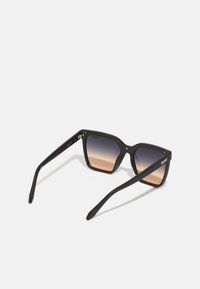 Black square sunglasses with gradient lenses, featuring a matte finish and gold hardware accents on the temples.