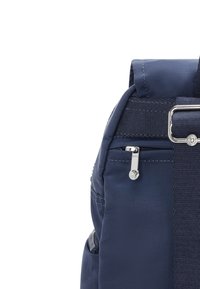 Navy blue backpack featuring a smooth texture, zippered pocket, and adjustable straps with metallic accents. Compact design for versatile use.