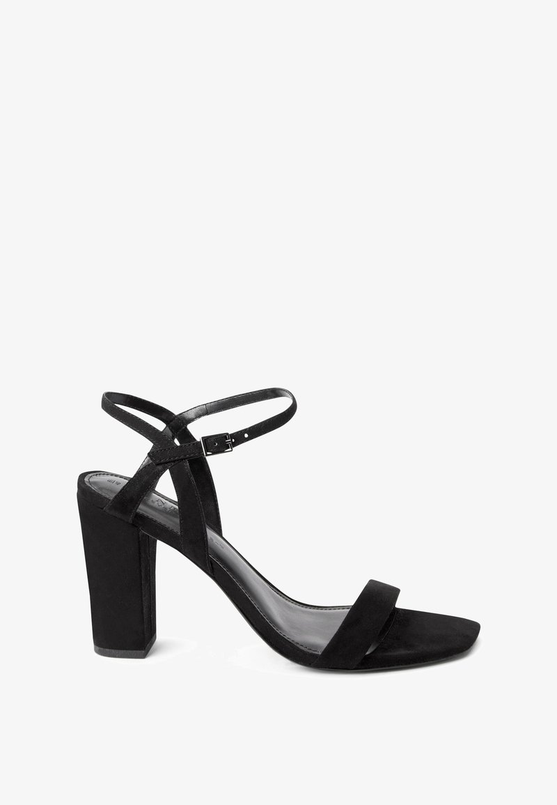 Black suede high-heeled sandal with a block heel, open toe, ankle strap, and small buckle, shown in side profile on a white background.