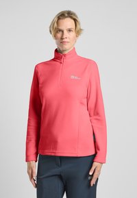 Pullover a maniche lunghe con zip, in felpa rosa brillante con una consistenza morbida; presenta un logo sulla parte superiore sinistra del petto e polsini aderenti.