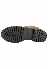 Semelle de botte en cuir marron avec des motifs de traction en caoutchouc noir et des grips surélevés. Présente un bout arrondi et un logo imprimé sur la section centrale.