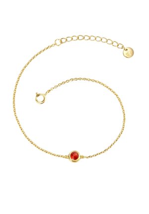 Gold chain bracelet featuring a round red gemstone in a circular setting, delicate twisted texture, with an adjustable clasp and small charm.