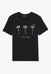 Black cotton t-shirt featuring white line drawings of three flowers and the text "bloom wildly" underneath. Round neck and short sleeves.