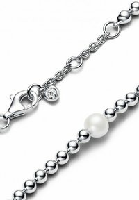 Sterling silver chain bracelet featuring a pearl bead and a small crystal accent, with a lobster clasp closure and smooth spherical beads.