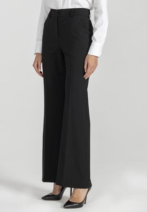 - Spodnie materiałowe