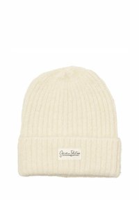 Koonustega ribakootud kreemivärvi beanie, millel on volditud ääre ja ees väike valge silt, millel on kirjas "Studio Edition".