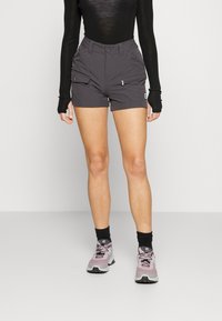 Gray athletic shorts with two side pockets, belt loops, and a button closure, paired with light purple running shoes and black ankle socks.