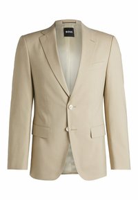 Blazer beige su misura con dettagli a revers, due tasche frontali, chiusura con un bottone e fodera interna a motivo. Tessuto morbido al tatto.